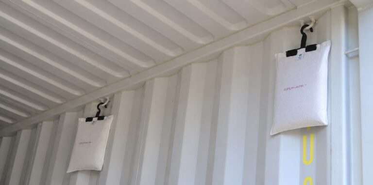 ES K container desiccant bags hanging on their hooks in the upper part of a shipping container wall